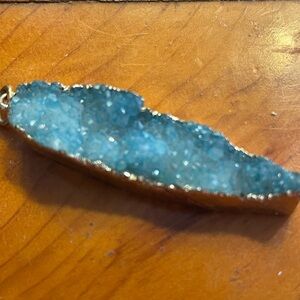 Pendant: stunning druzy the color of the sea stone set in gold. 2" x 1/2".